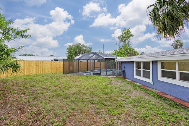 view of yard with a lanai and a fenced in pool