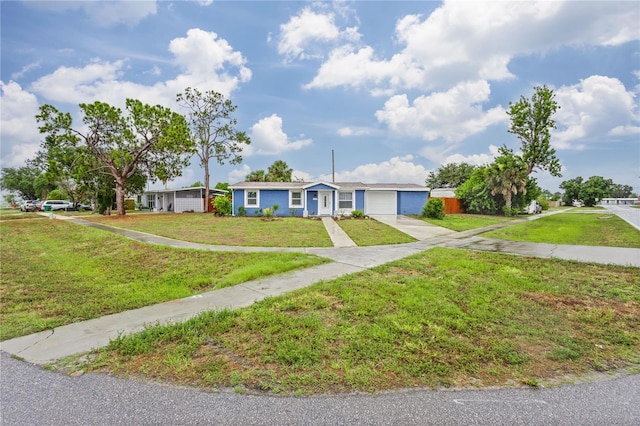 single story home featuring a front yard and a garage