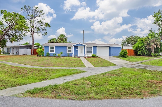 single story home featuring a garage and a front yard