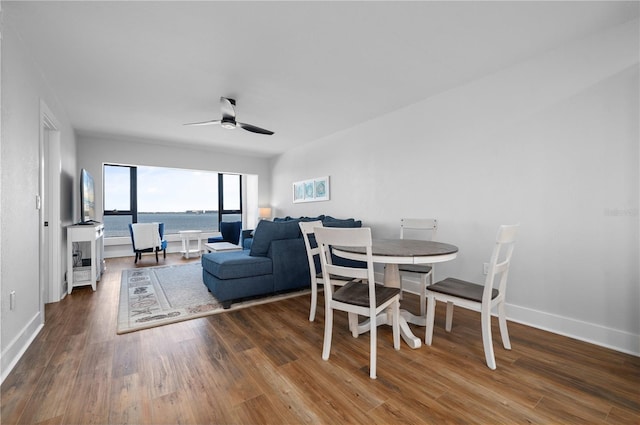 dining space with ceiling fan and hardwood / wood-style floors