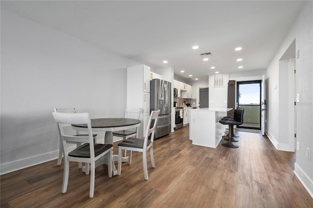 dining room with wood-type flooring