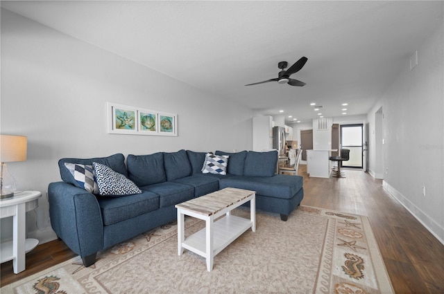 living room with ceiling fan and hardwood / wood-style floors