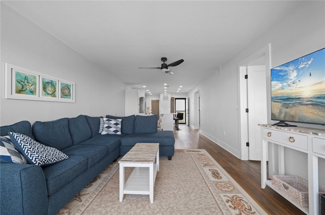 living room featuring hardwood / wood-style flooring and ceiling fan