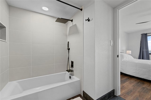 bathroom with tiled shower / bath combo and wood-type flooring