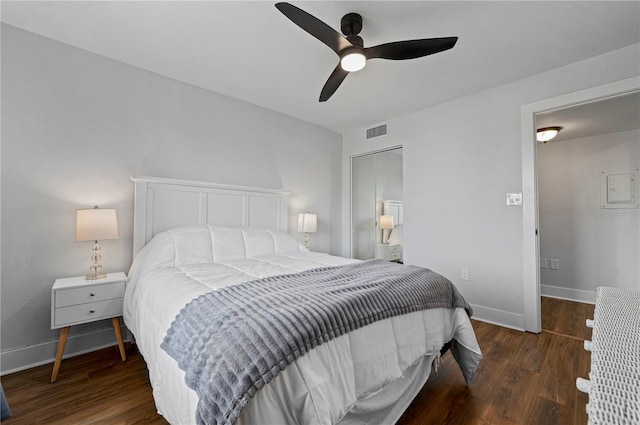 bedroom featuring a closet, ceiling fan, and dark hardwood / wood-style flooring