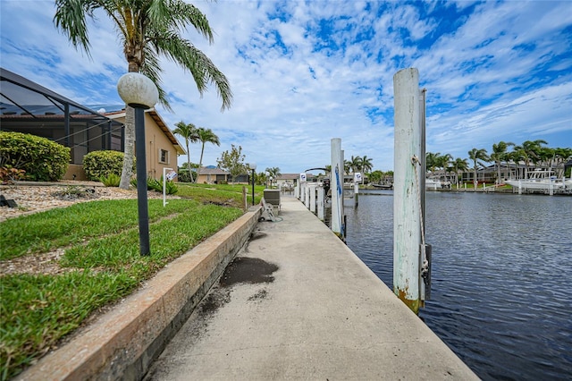 dock area with glass enclosure and a water view