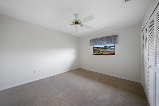 unfurnished bedroom featuring carpet flooring, ceiling fan, and a closet