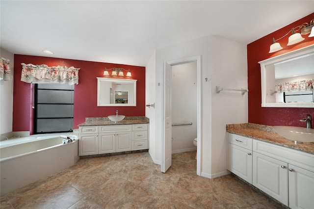 bathroom featuring a bathing tub, vanity, and toilet