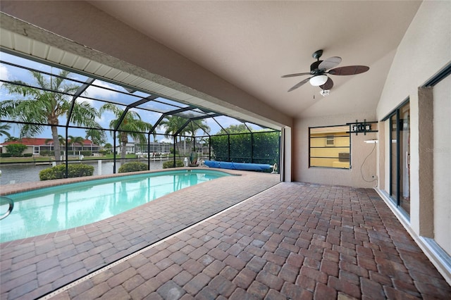 view of swimming pool with a patio, a water view, glass enclosure, and ceiling fan