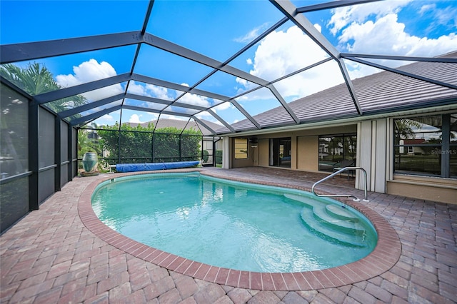 view of pool with a patio area and a lanai