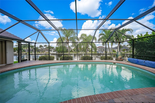 view of pool featuring a lanai and a water view