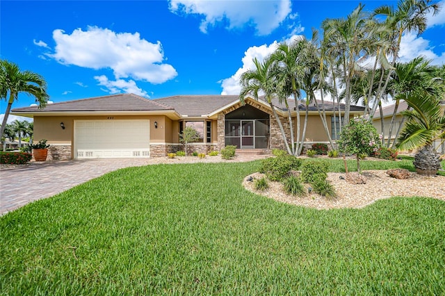 view of front of property with a garage and a front lawn