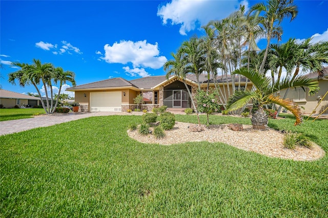 single story home with a garage and a front lawn