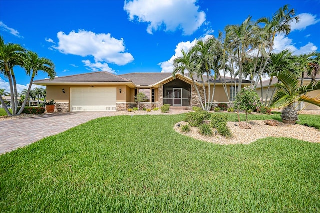 view of front of home with a front yard and a garage