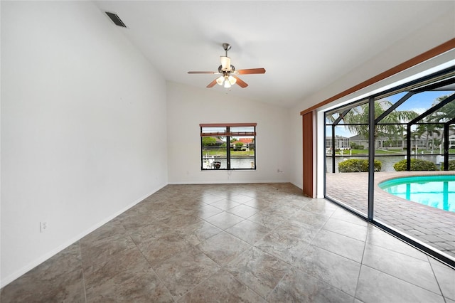 empty room with ceiling fan and lofted ceiling