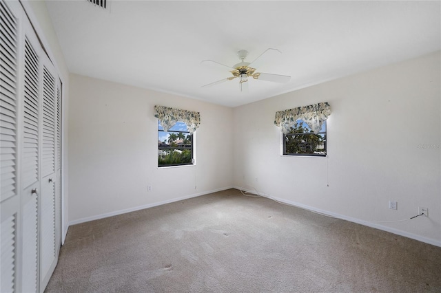 unfurnished bedroom featuring ceiling fan, a closet, and carpet