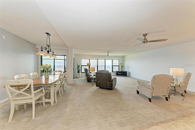 dining room featuring ceiling fan, a healthy amount of sunlight, and a textured ceiling