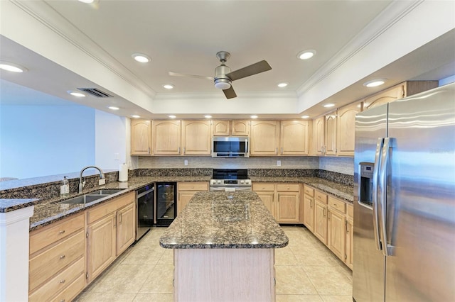 kitchen featuring dark stone countertops, light brown cabinetry, sink, and appliances with stainless steel finishes