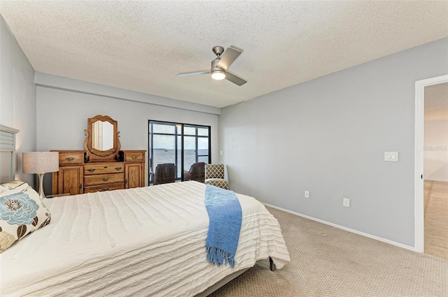 carpeted bedroom with a textured ceiling and ceiling fan