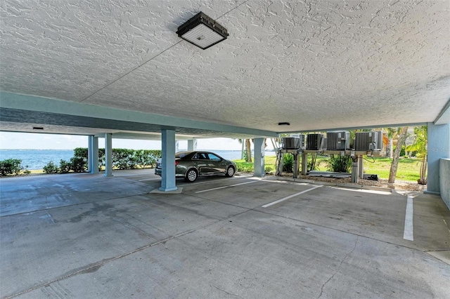 view of parking / parking lot with a water view