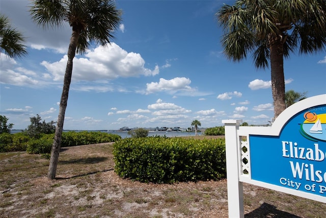 community / neighborhood sign with a water view