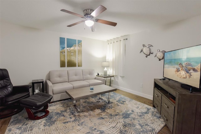 living room featuring ceiling fan and dark hardwood / wood-style floors