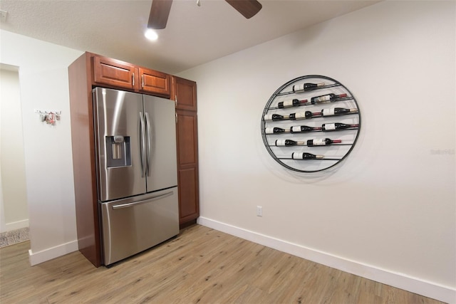 kitchen with ceiling fan, stainless steel fridge, and light hardwood / wood-style flooring