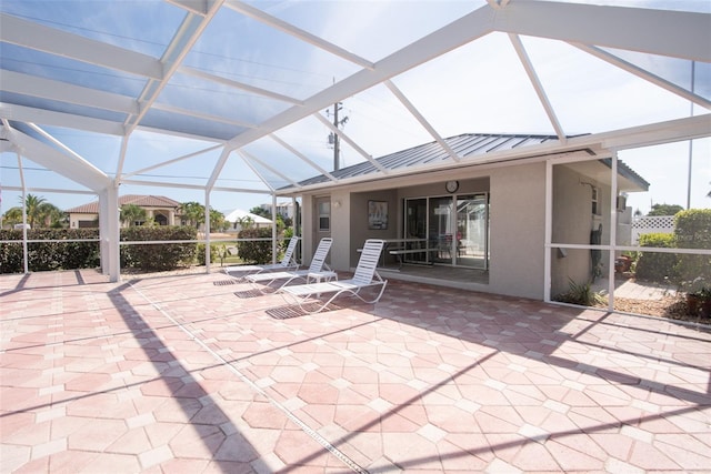 unfurnished sunroom featuring lofted ceiling and a healthy amount of sunlight