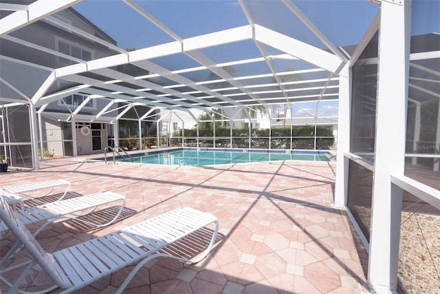 view of swimming pool with glass enclosure and a patio