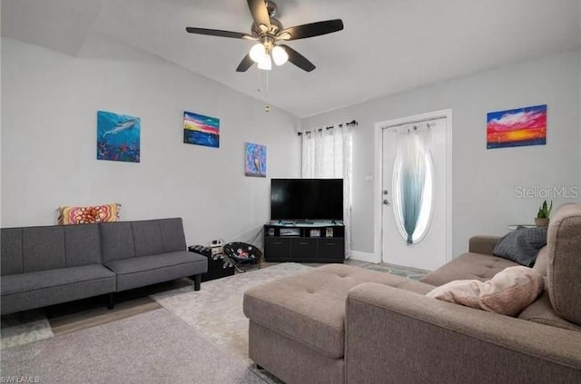 living room featuring lofted ceiling, light colored carpet, and ceiling fan