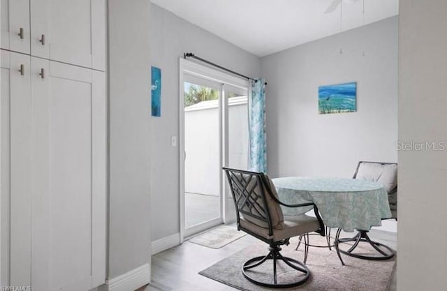 dining space with ceiling fan and hardwood / wood-style flooring