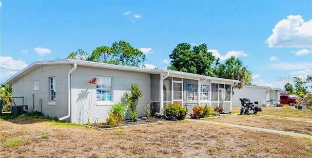 view of front of house with cooling unit and a sunroom