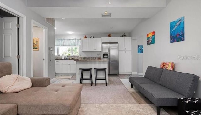 living room featuring lofted ceiling