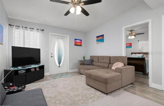 living room with ceiling fan and light hardwood / wood-style floors