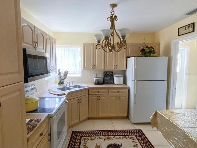 kitchen with an inviting chandelier, white appliances, backsplash, pendant lighting, and light tile floors