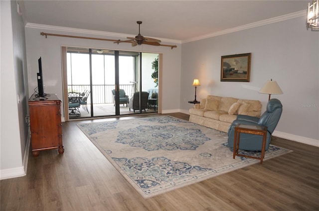 living room featuring dark hardwood / wood-style flooring, ceiling fan, and crown molding