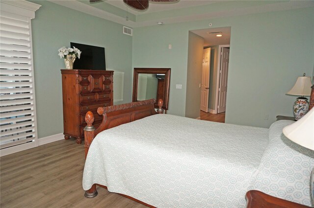 bedroom with ceiling fan and hardwood / wood-style flooring