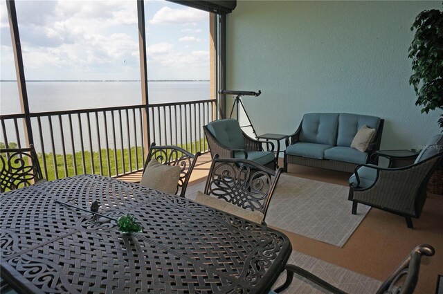 sunroom / solarium with a water view