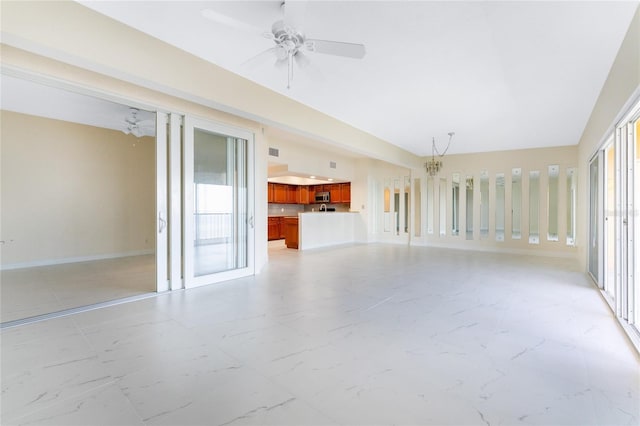 unfurnished living room featuring ceiling fan and a healthy amount of sunlight