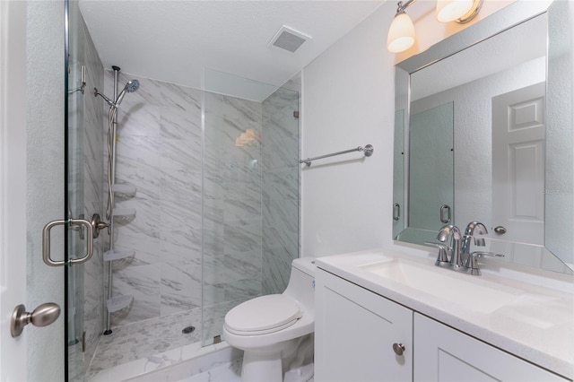 bathroom featuring vanity, toilet, and a shower with shower door