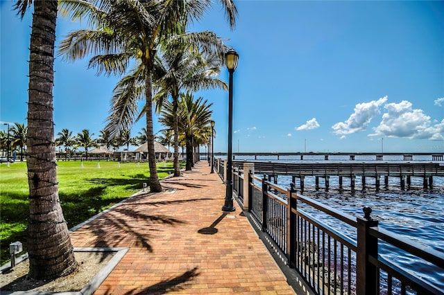 dock area with a yard and a water view