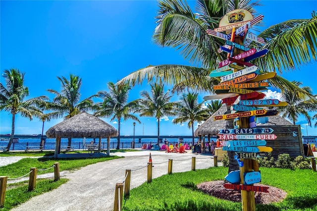 surrounding community with a gazebo, a water view, and a yard