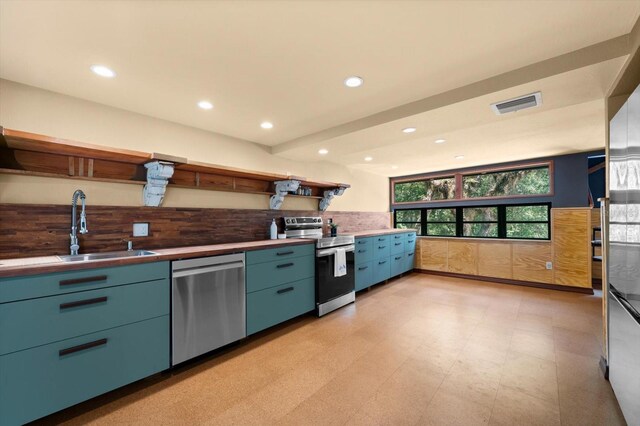 kitchen with visible vents, appliances with stainless steel finishes, light floors, open shelves, and a sink