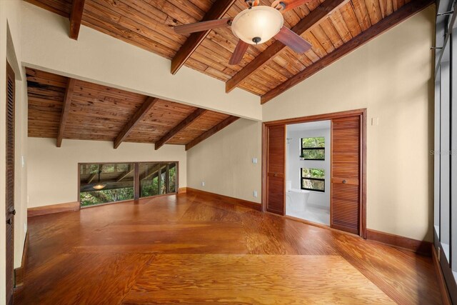 unfurnished living room featuring wood ceiling, ceiling fan, wood finished floors, beamed ceiling, and baseboards