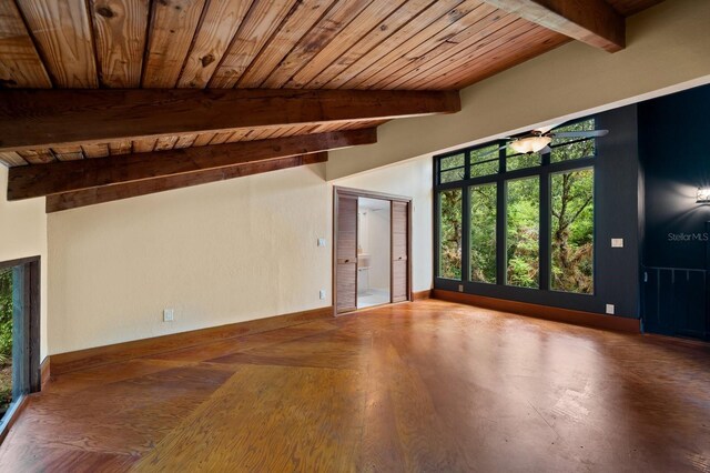 interior space with wood ceiling, a healthy amount of sunlight, and baseboards