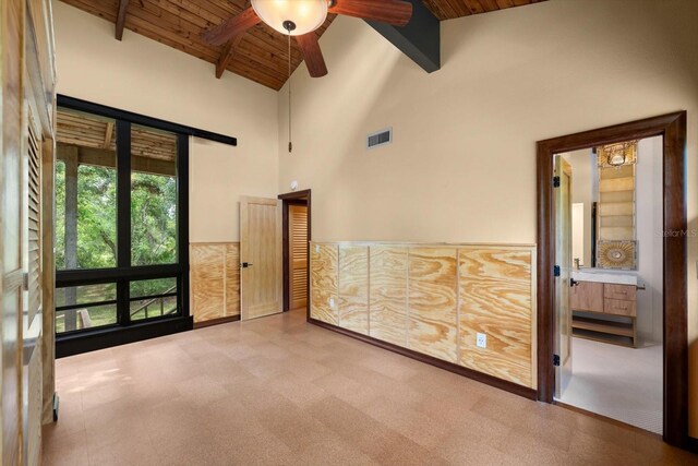 empty room with high vaulted ceiling, wooden ceiling, visible vents, and beamed ceiling