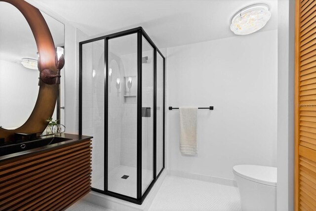 full bath featuring a stall shower, baseboards, toilet, tile patterned flooring, and vanity