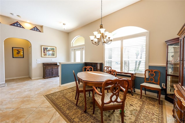 tiled dining area with a chandelier and a healthy amount of sunlight