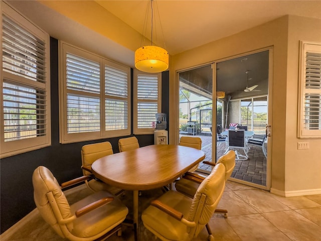 tiled dining space with ceiling fan