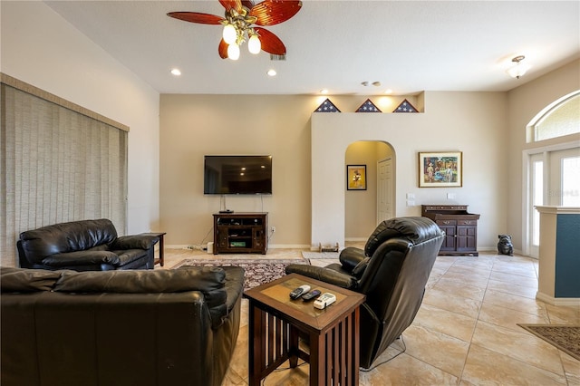 tiled living room with ceiling fan